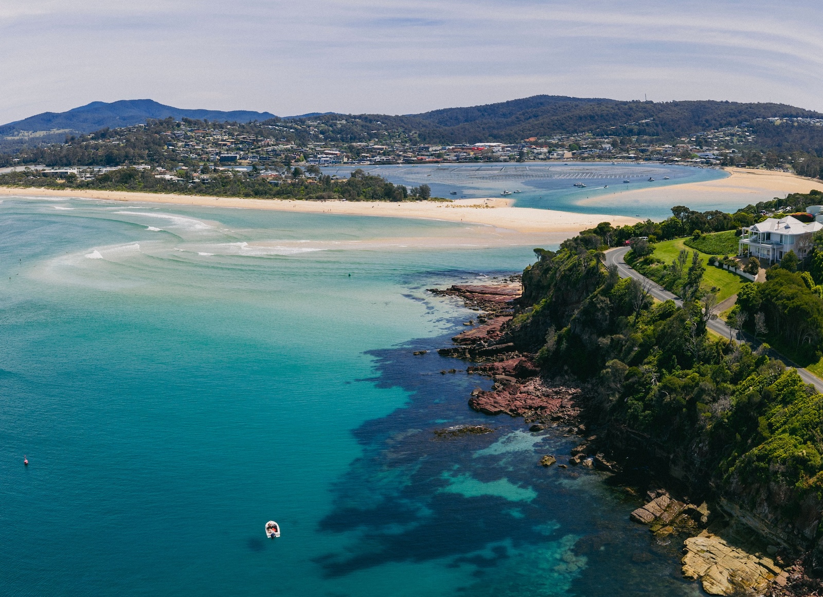 South Coast NSW beach and bushland — white sand and clear water